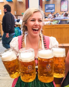 how to be happy; girl at Oktoberfest holding 4 pints of beer