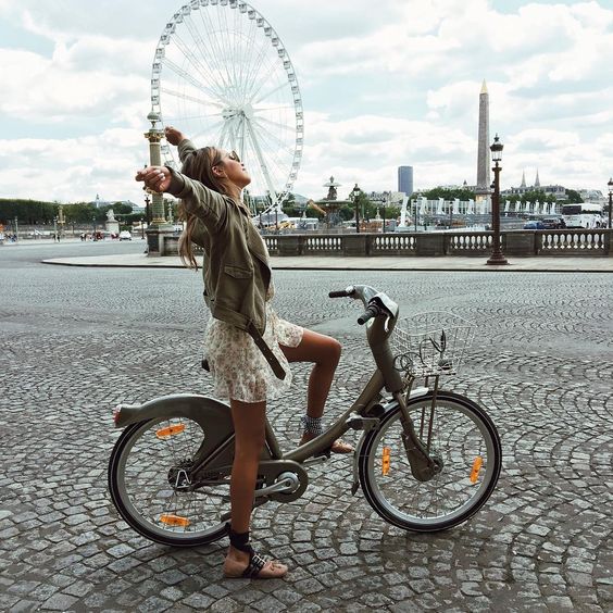 Travel When You Have a Bad Back; tourist girl stretch on bike in Paris France