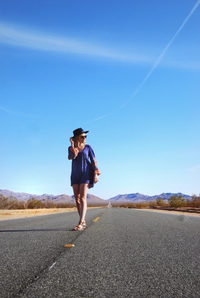 epic road trip to Las Vegas from Los Angeles; girl boho walking road