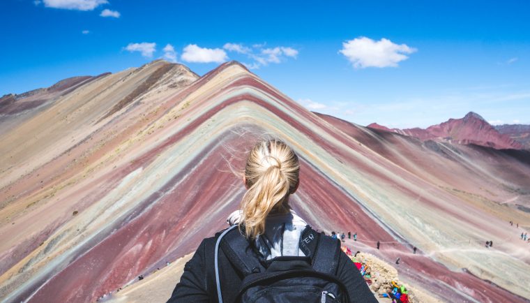 traveling with HYLETE; girl hiking rainbow mountain in Peru