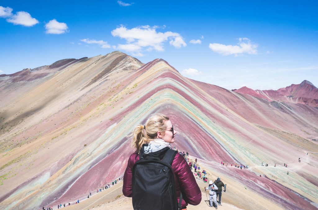 avoid altitude sickness in Peru; girl trekking Rainbow Mountain