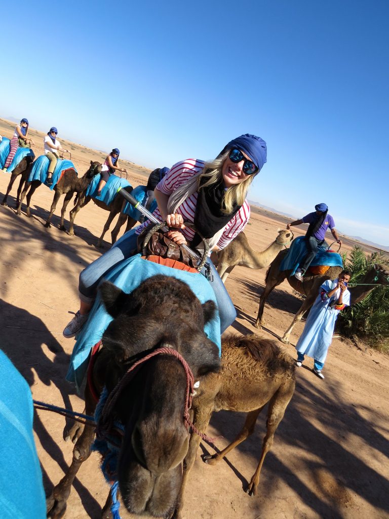 travel and reduce your carbon footprint; girl on camel
