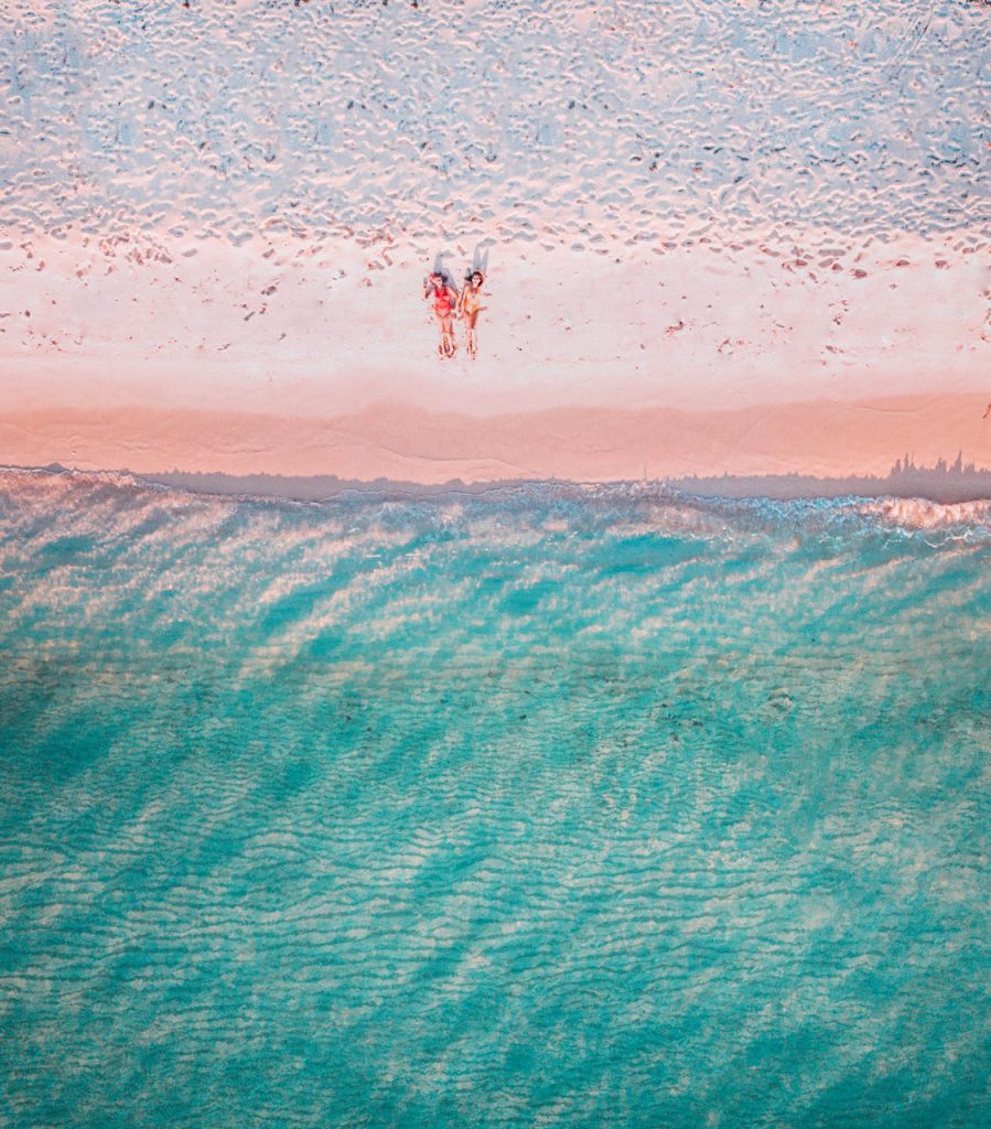 southwest Dominican Republic; girls laying on the beach; aerial drone shot of Bahia de las Aguilas