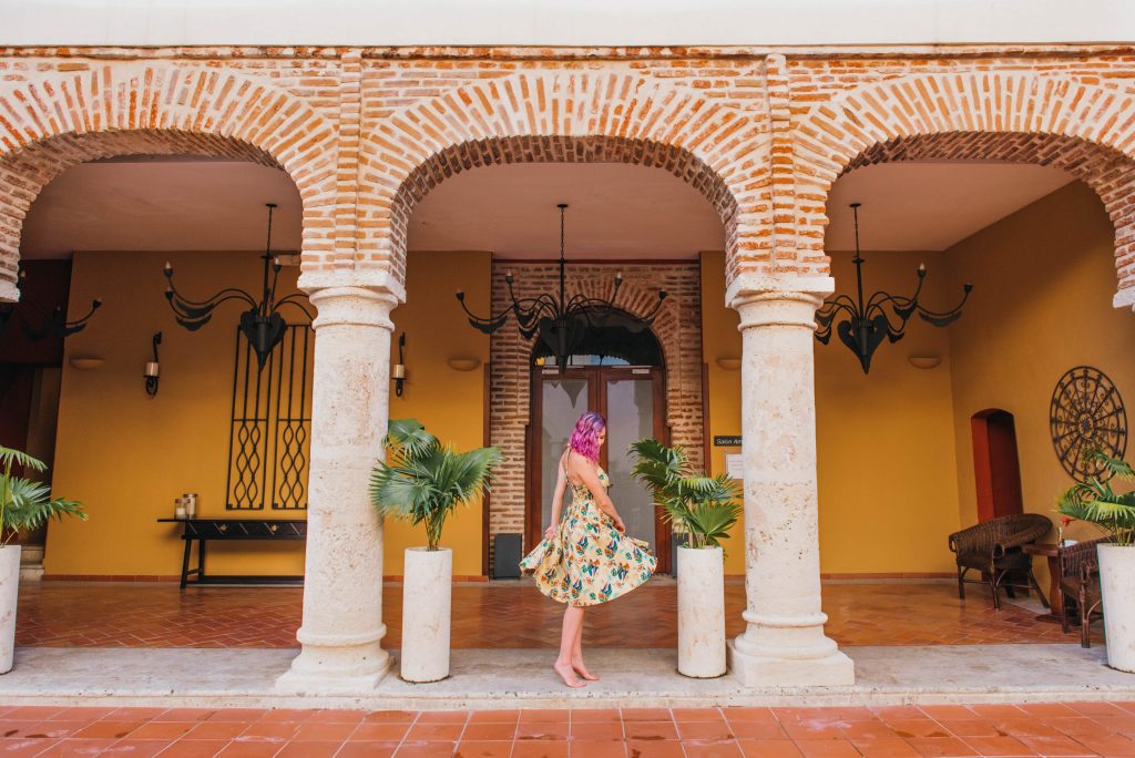 24 Hours in Santo Domingo; Hodelpa Nicolás de Ovando interior red brick girl dancing in yellow dress