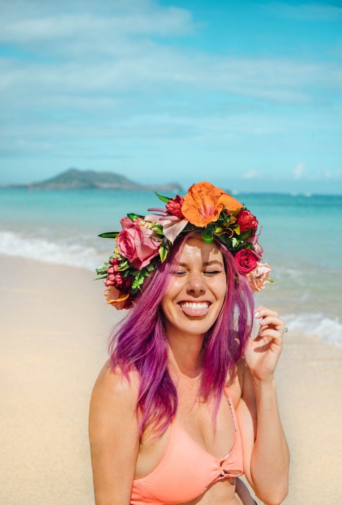 2017 was the best; purple hair girl laughing on the beach with hawaiian flower crown