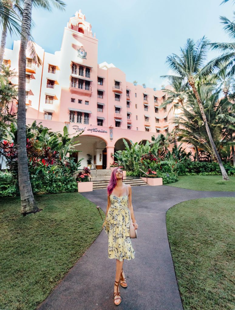2017 was the best; girl walking in yellow dress in front of Royal Hawaiian Hotel on Oahu