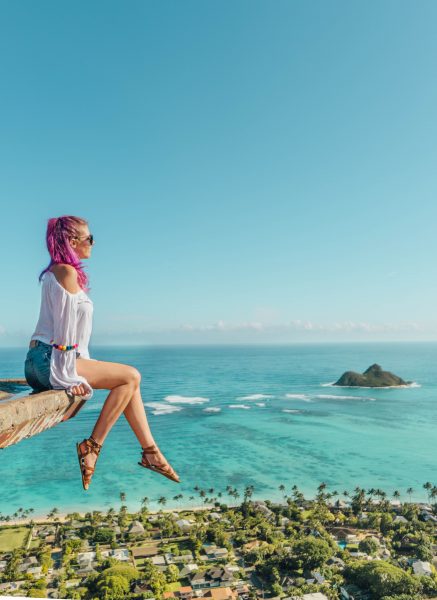 best things to do in Oahu; girl sitting and looking at view from the Lanikai Pillbox trail hike