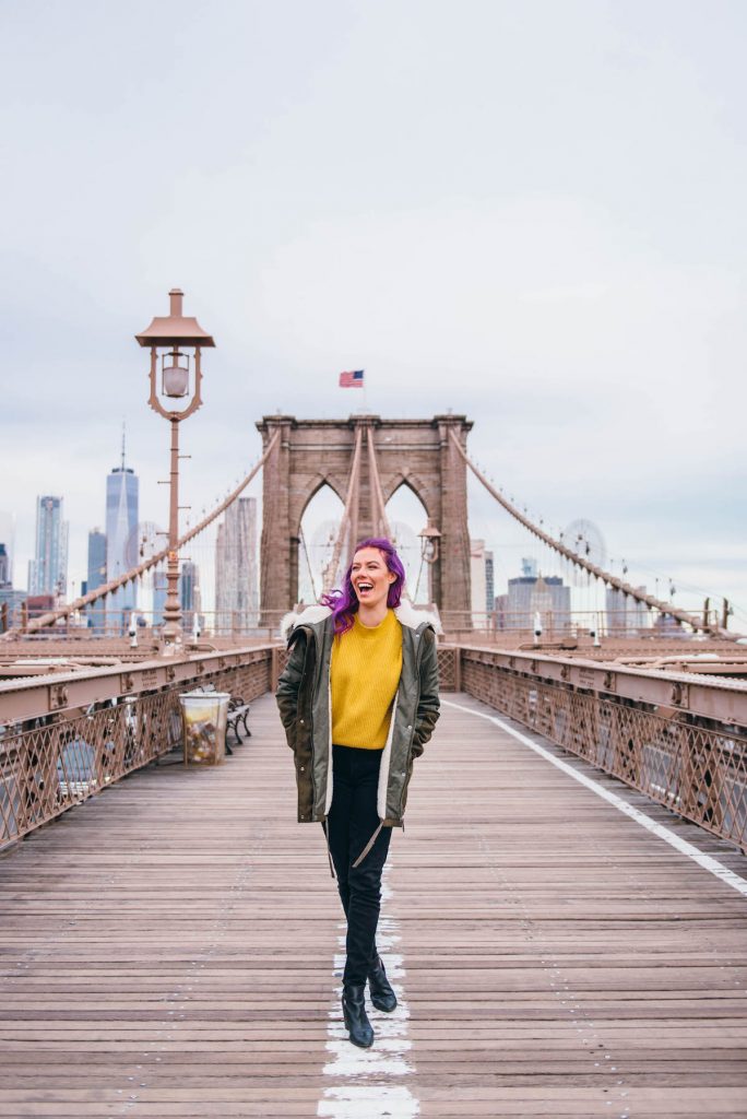 48 hours in New York; Girl walking across Brooklyn Bridge sunrise