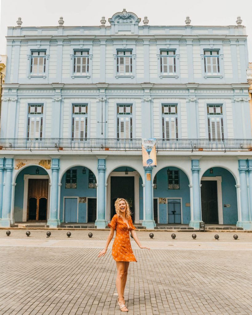 havana cuba photography; girl in front of plaza vieja blue building